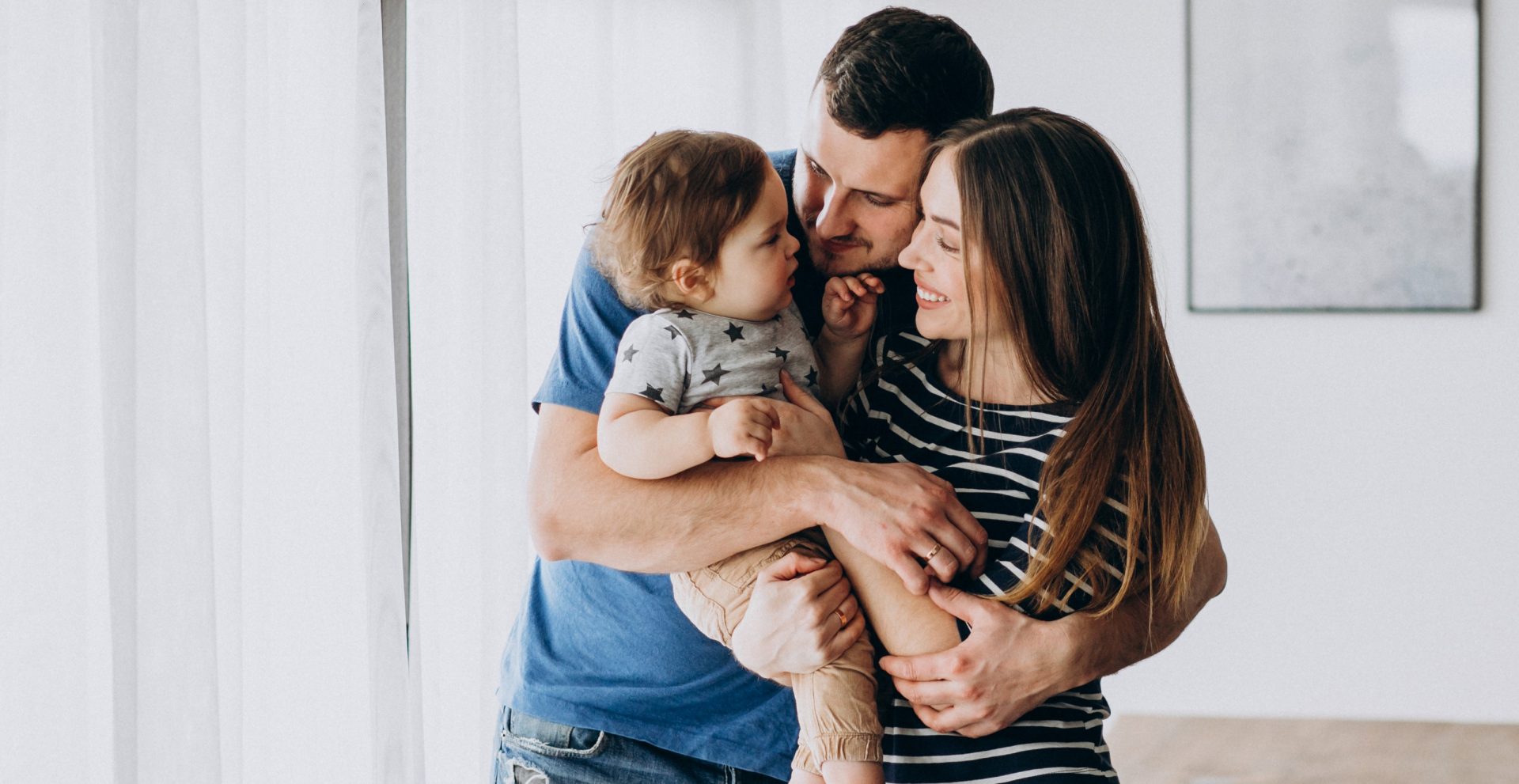 Young family with their little son at home